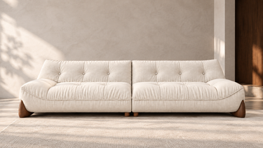 AI-styled front-facing room scene featuring the HATX-1020 beige sofa with buttoned cushions and sculptural wooden feet. Room styling is not included.